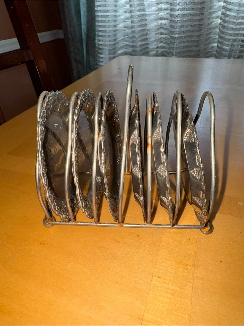 six vintage silver-plated drink coasters with ornate, embossed floral